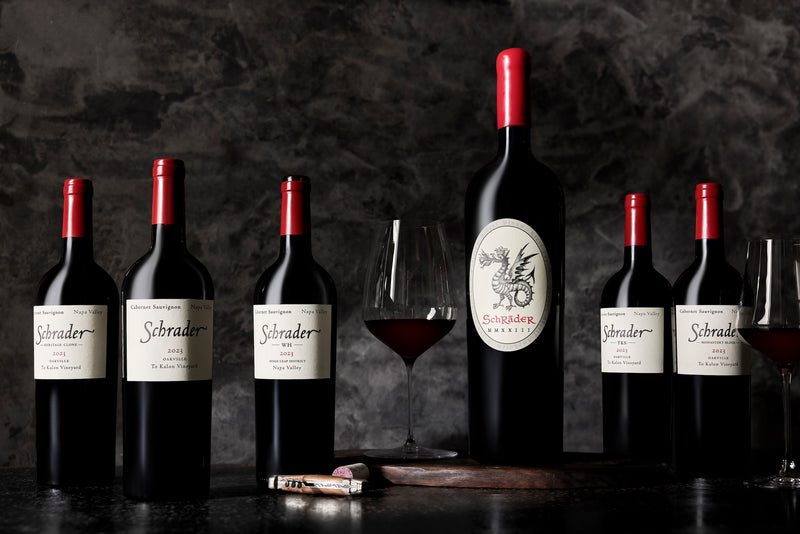 A line of Schrader wine bottles with the label facing to the left